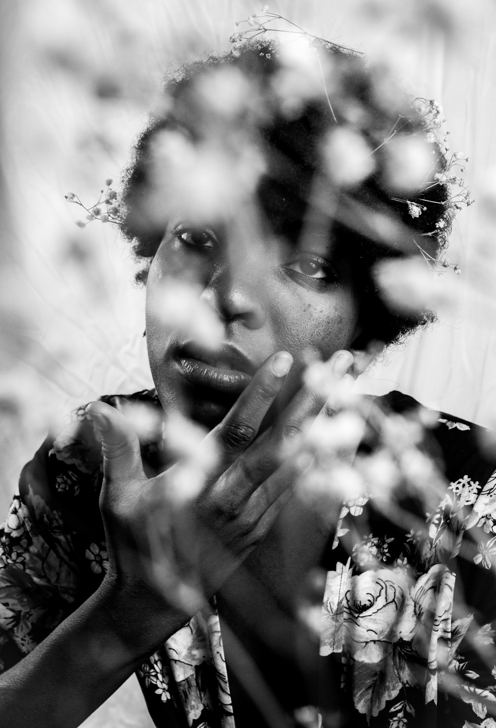 a black and white photo of a woman holding her hands together