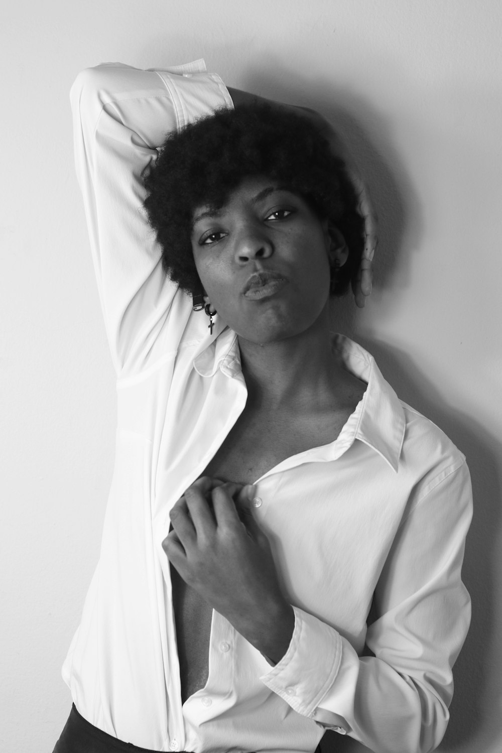 a black and white photo of a woman wearing a shirt