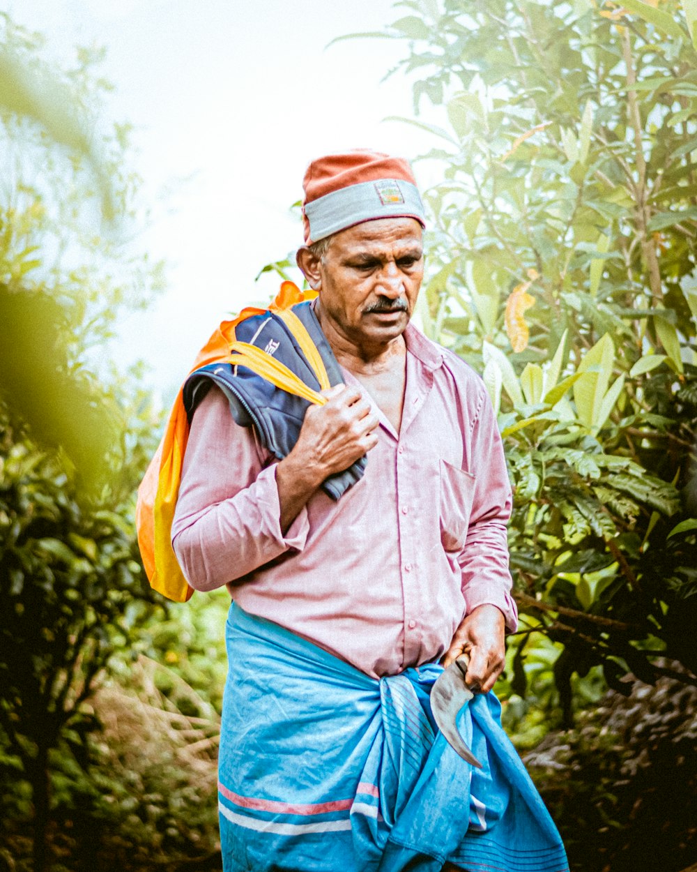 a man with a backpack walking through a forest