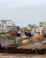 a group of people sitting on top of a wooden boat