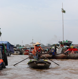 a group of people riding on top of boats in the water