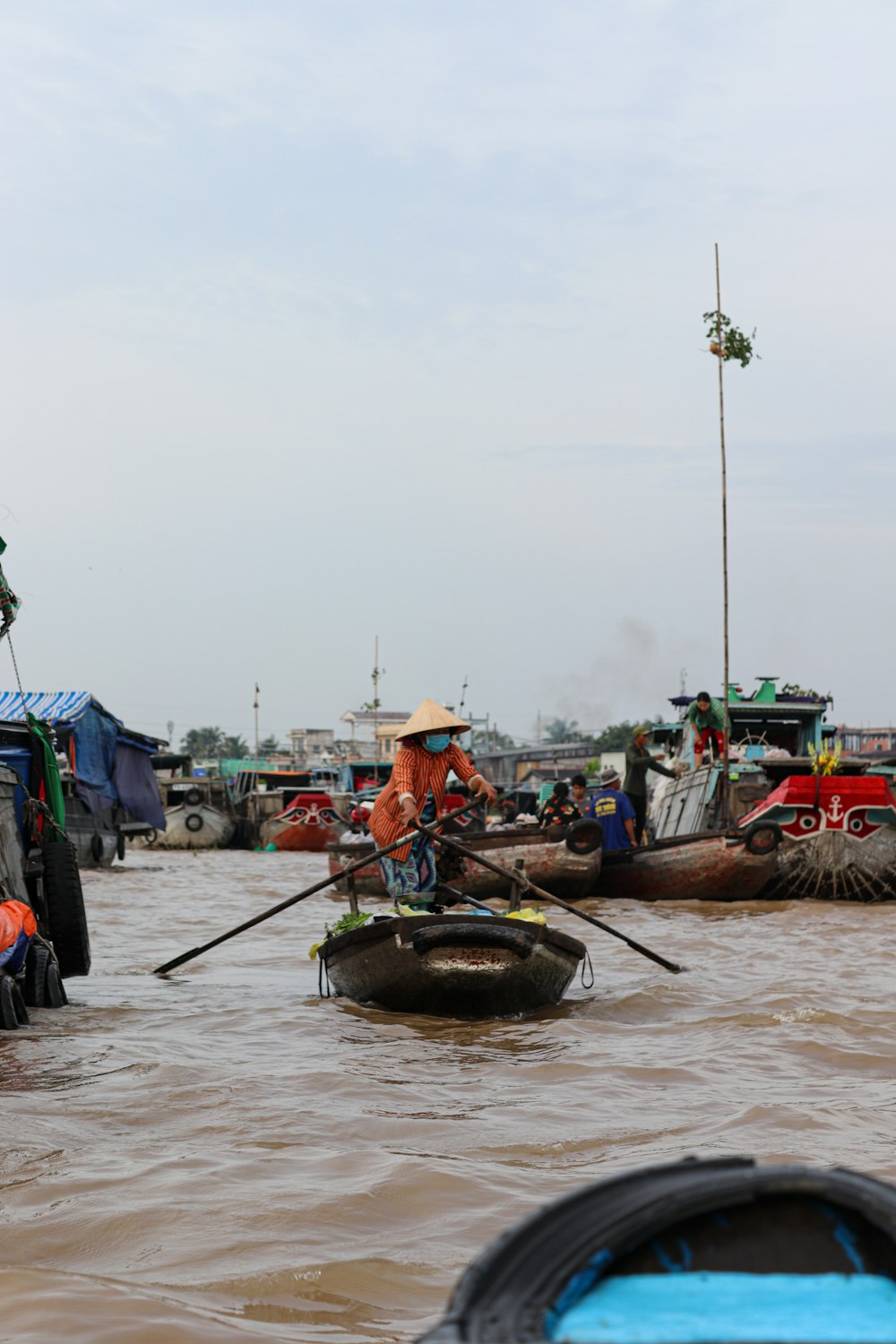 a group of people riding on top of boats in the water