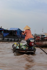 a woman is rowing a boat in the water