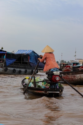 a woman is rowing a boat in the water