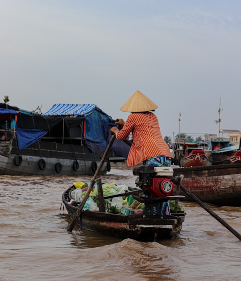 a woman is rowing a boat in the water