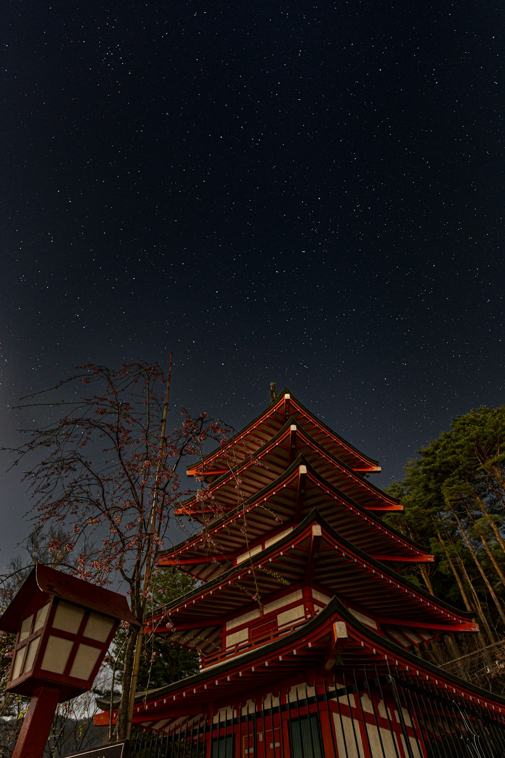 a tall red building sitting under a night sky
