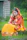 a woman sitting in the grass talking on a cell phone