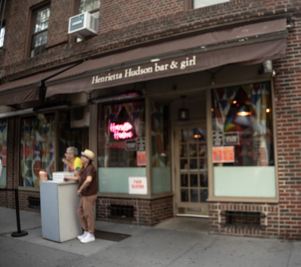 a man standing in front of a store on a city street