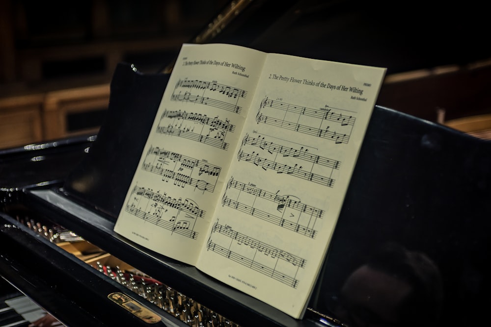 a sheet of music sitting on top of a piano