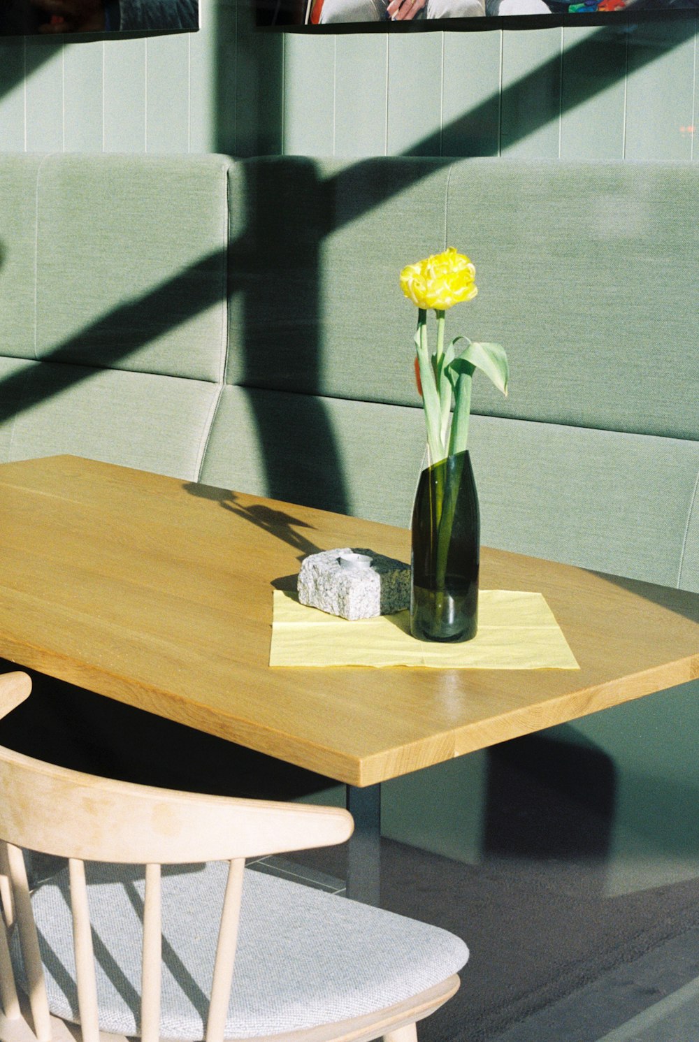 a wooden table with a vase of flowers on it