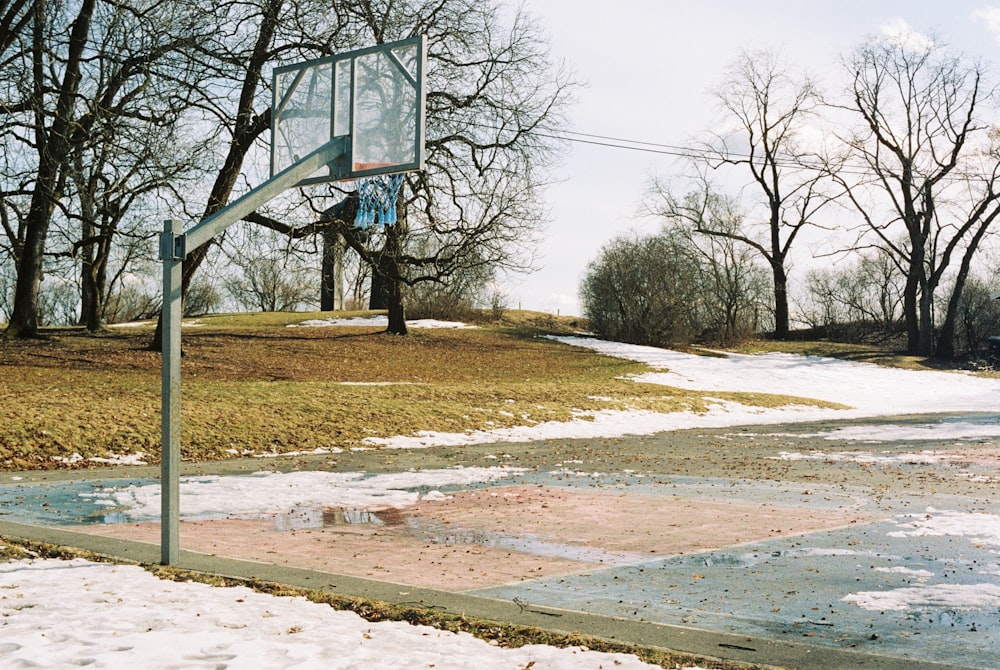 a basketball hoop in the middle of a snowy field