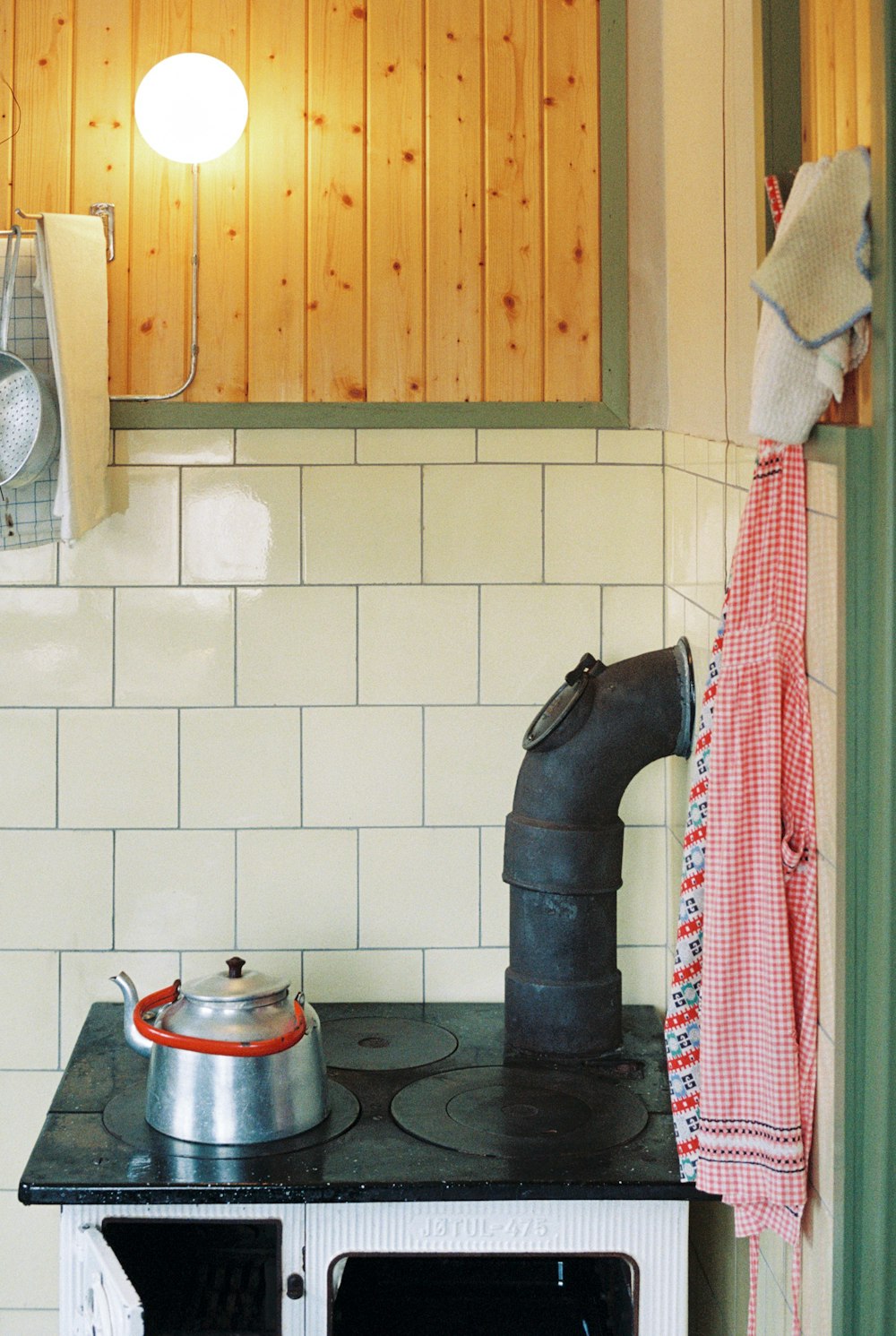 a stove top oven sitting inside of a kitchen