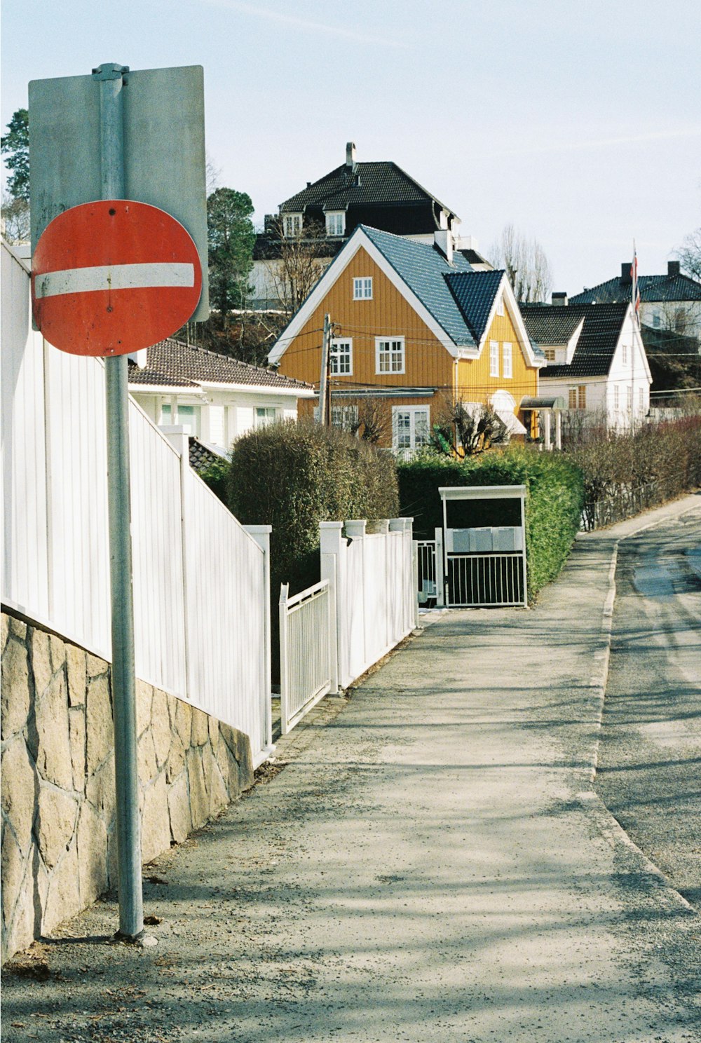 a red and white street sign sitting on the side of a road