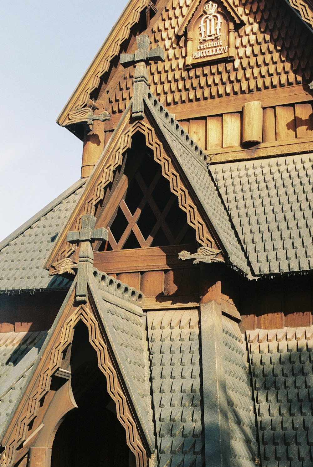 a large wooden building with a clock on the top of it