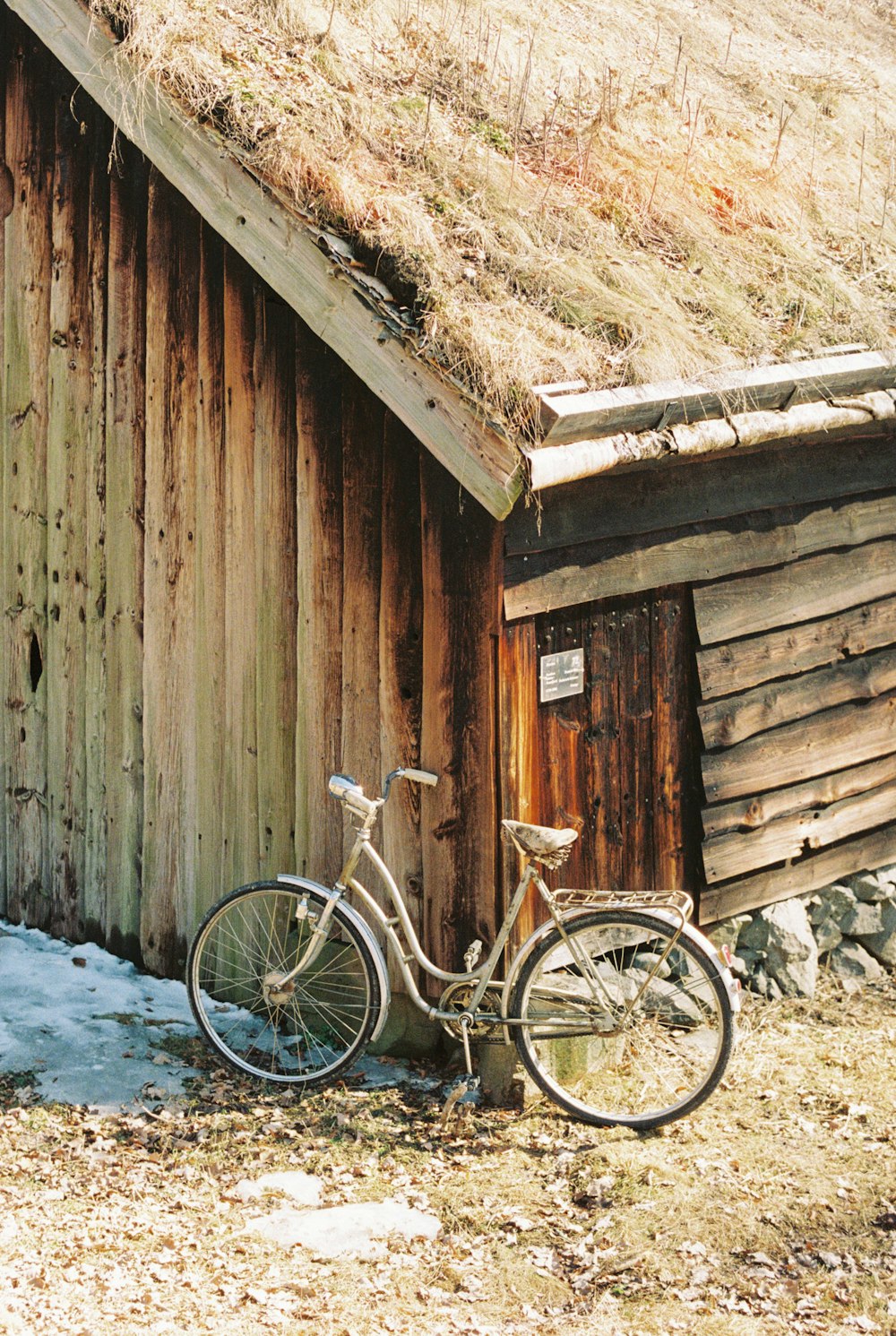 a bike parked next to a wooden building
