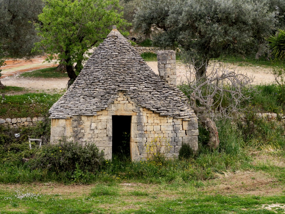 an old stone building with a thatched roof