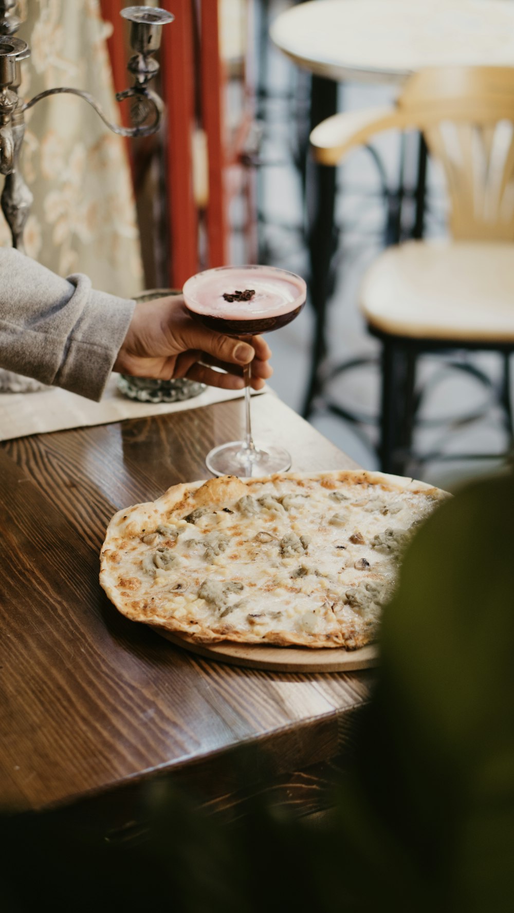 a person sitting at a table with a pizza on it