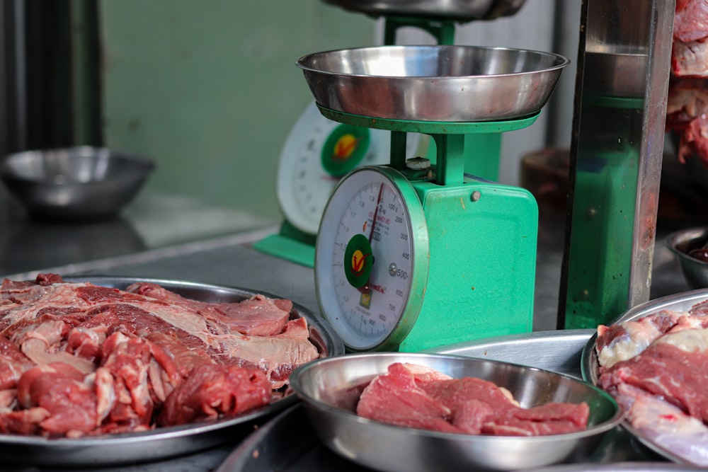 meat is being weighed on a scale in a kitchen