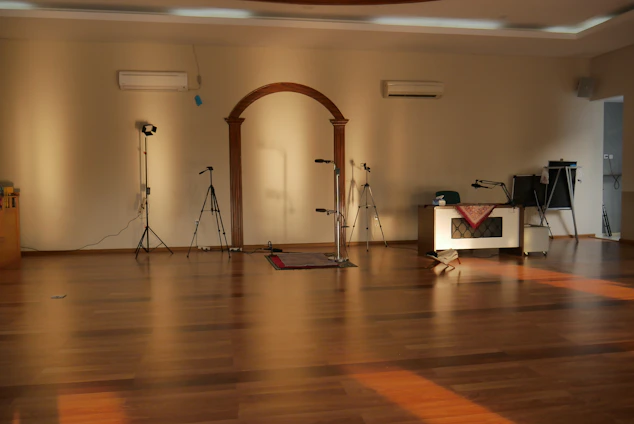 A cozy rehearsal room with scripts scattered on a wooden table and warm light spilling in through a window.