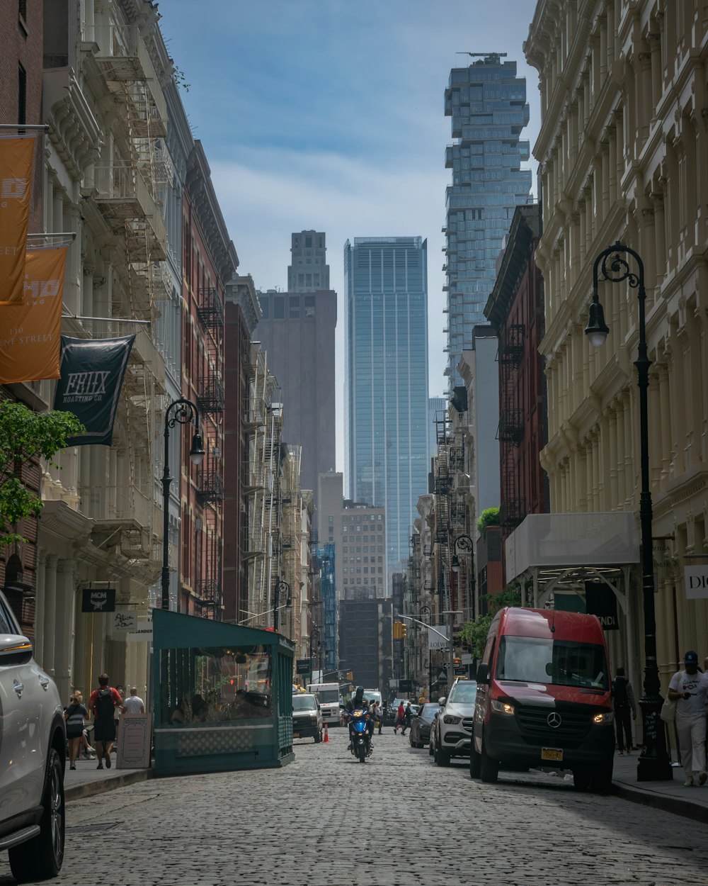 a cobblestone street in a city with tall buildings