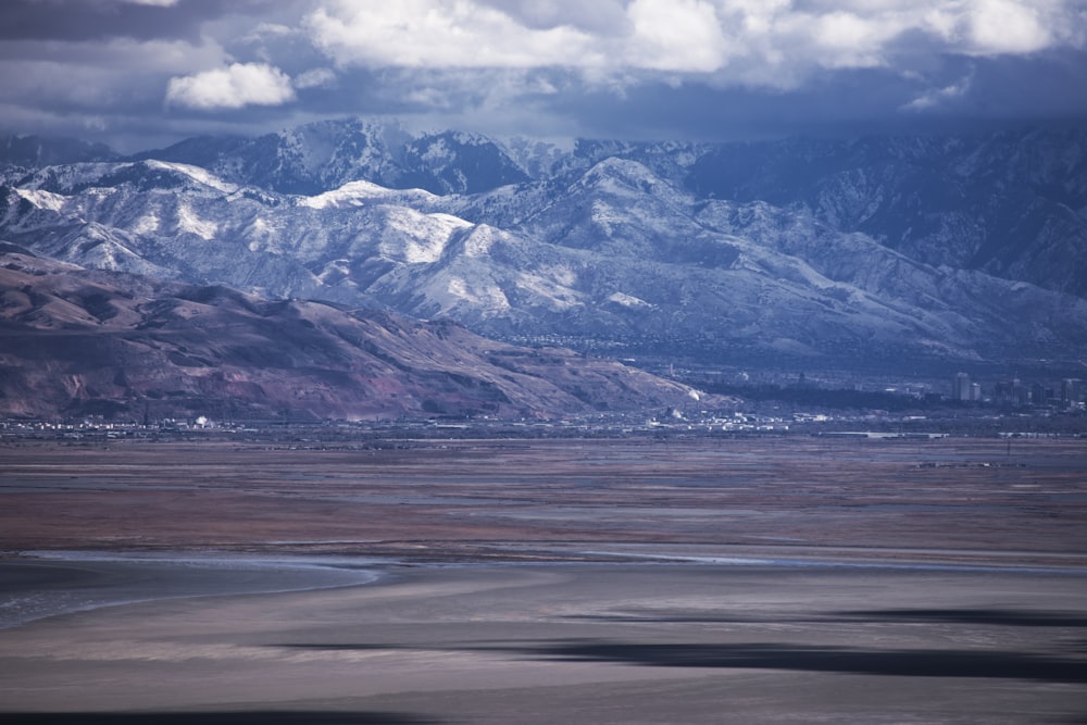 a mountain range with a body of water in the foreground