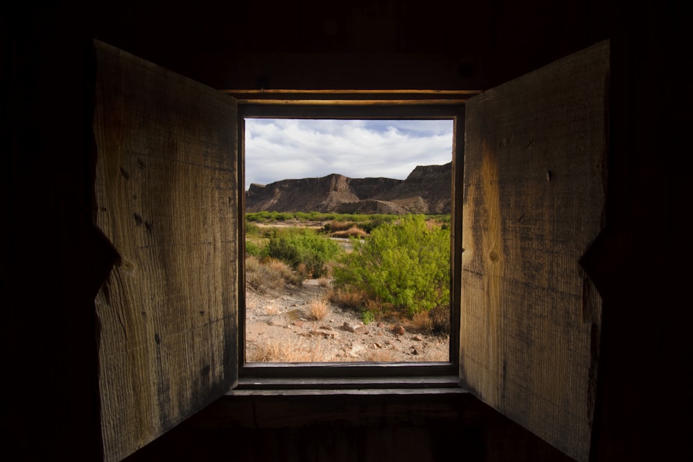 an open window with a view of a desert
