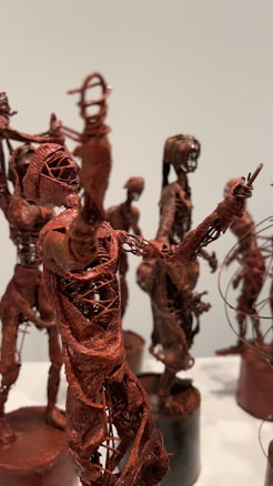 Intricately crafted sculptures made of wire and possibly clay or resin. The sculptures depict abstract human figures in various poses, with visible details resembling muscles and ligaments. The overall appearance is artistic and thought-provoking.