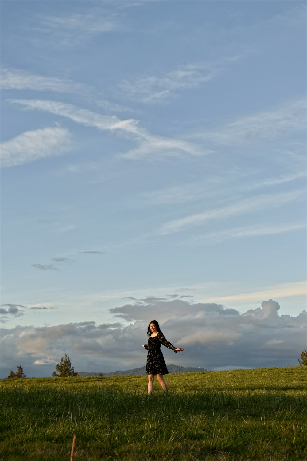 a woman standing on top of a lush green field