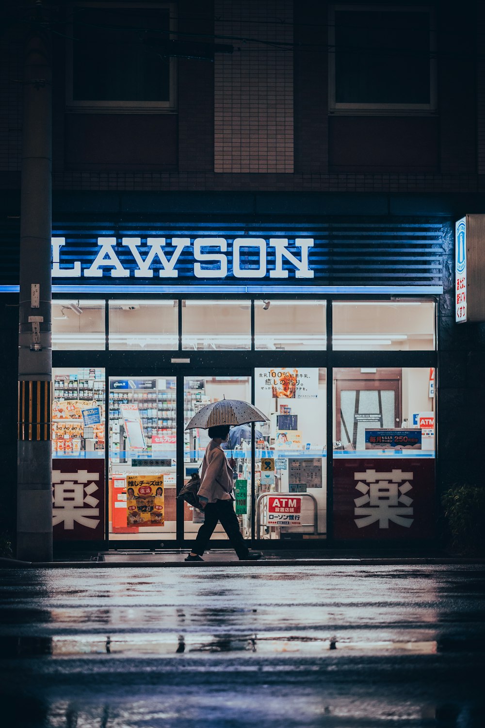 a person walking down a street holding an umbrella