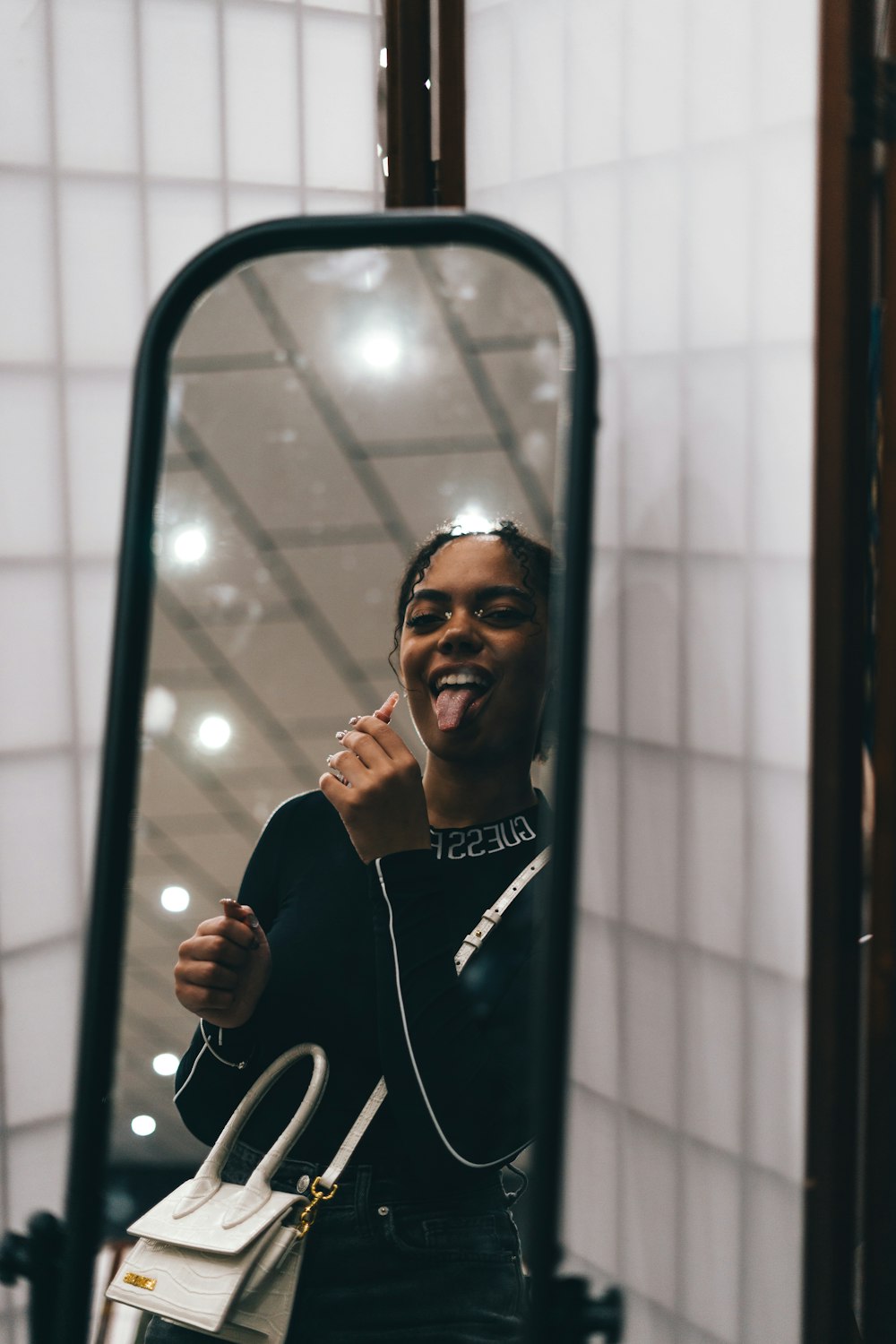 a woman is taking a selfie in a mirror