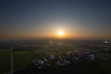 A sunset over fields illustrating village life.