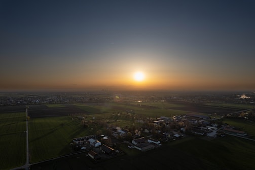 A sunset over fields illustrating village life.