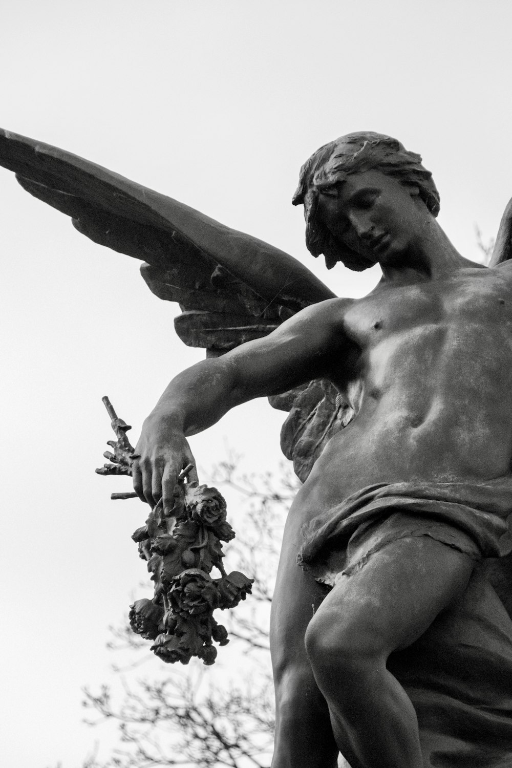 a statue of a man holding a bunch of flowers