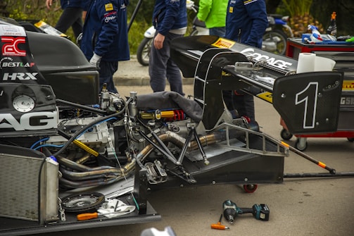 A team of auto experts collaborating on a car project.