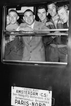 A friendly travel consultant smiling while assisting clients with European tour plans.