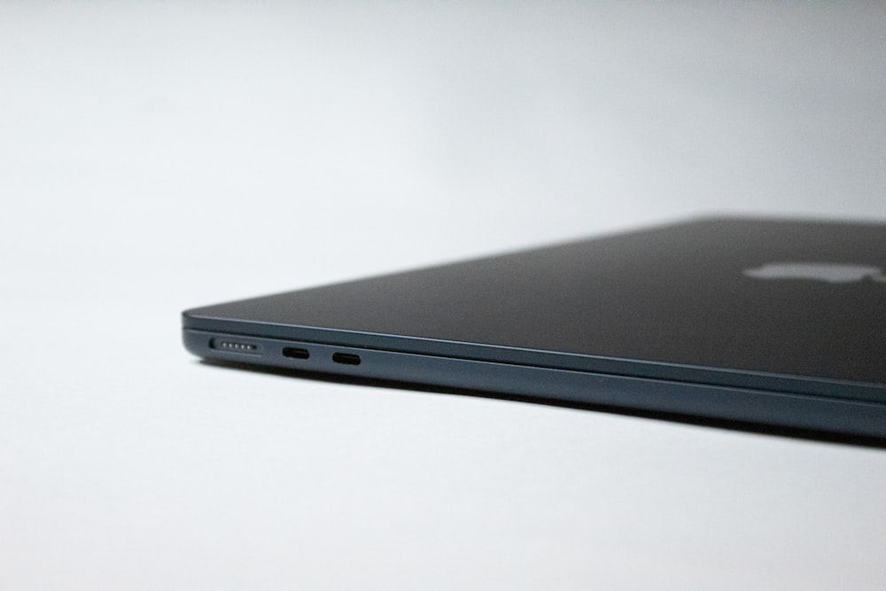 a close up of an apple laptop on a table