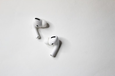 Compact wireless earbuds displayed on a clean white surface.