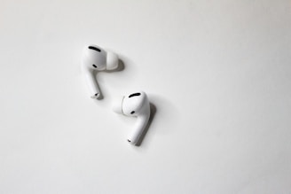 Compact wireless earbuds displayed on a clean white surface.
