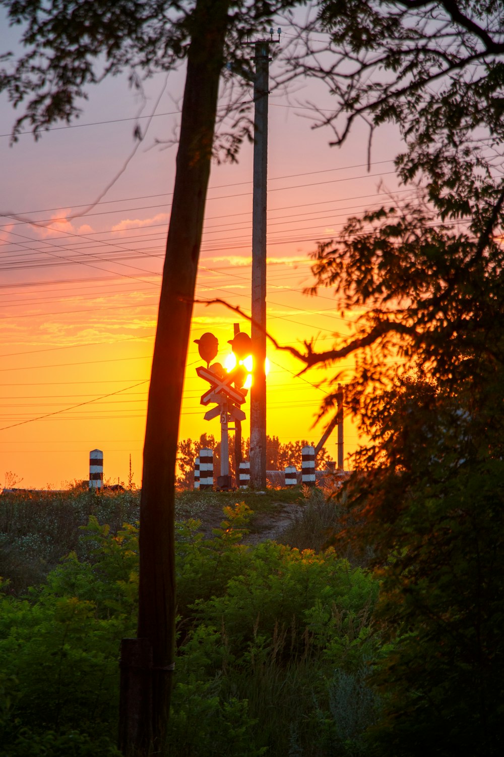 the sun is setting behind a power plant