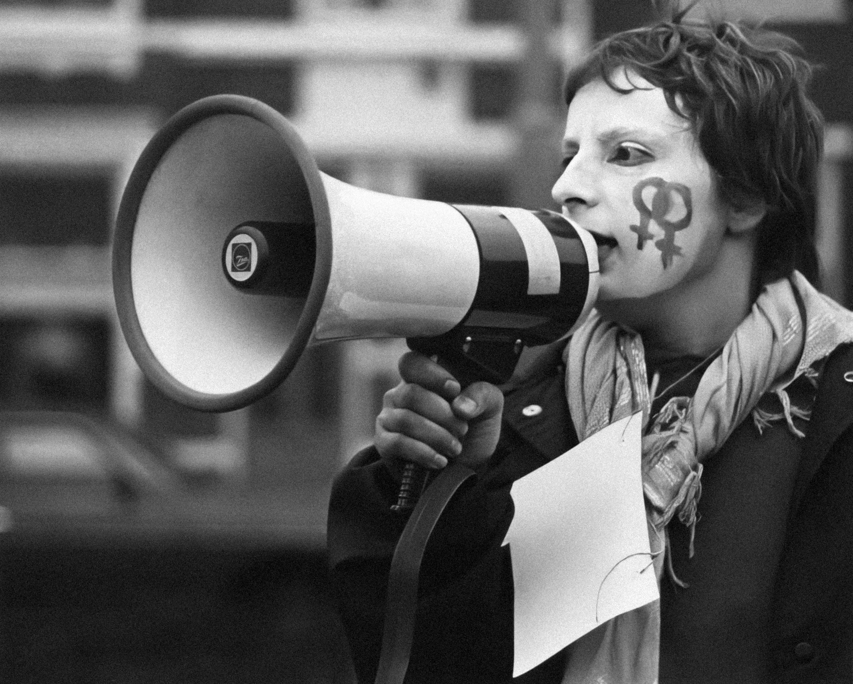 a man with a painted face and a megaphone