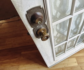 a close up of a door handle on a glass door