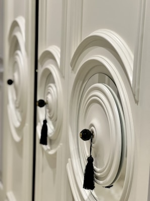 Close-up of a smooth, freshly painted white kitchen cabinet door with modern hardware.