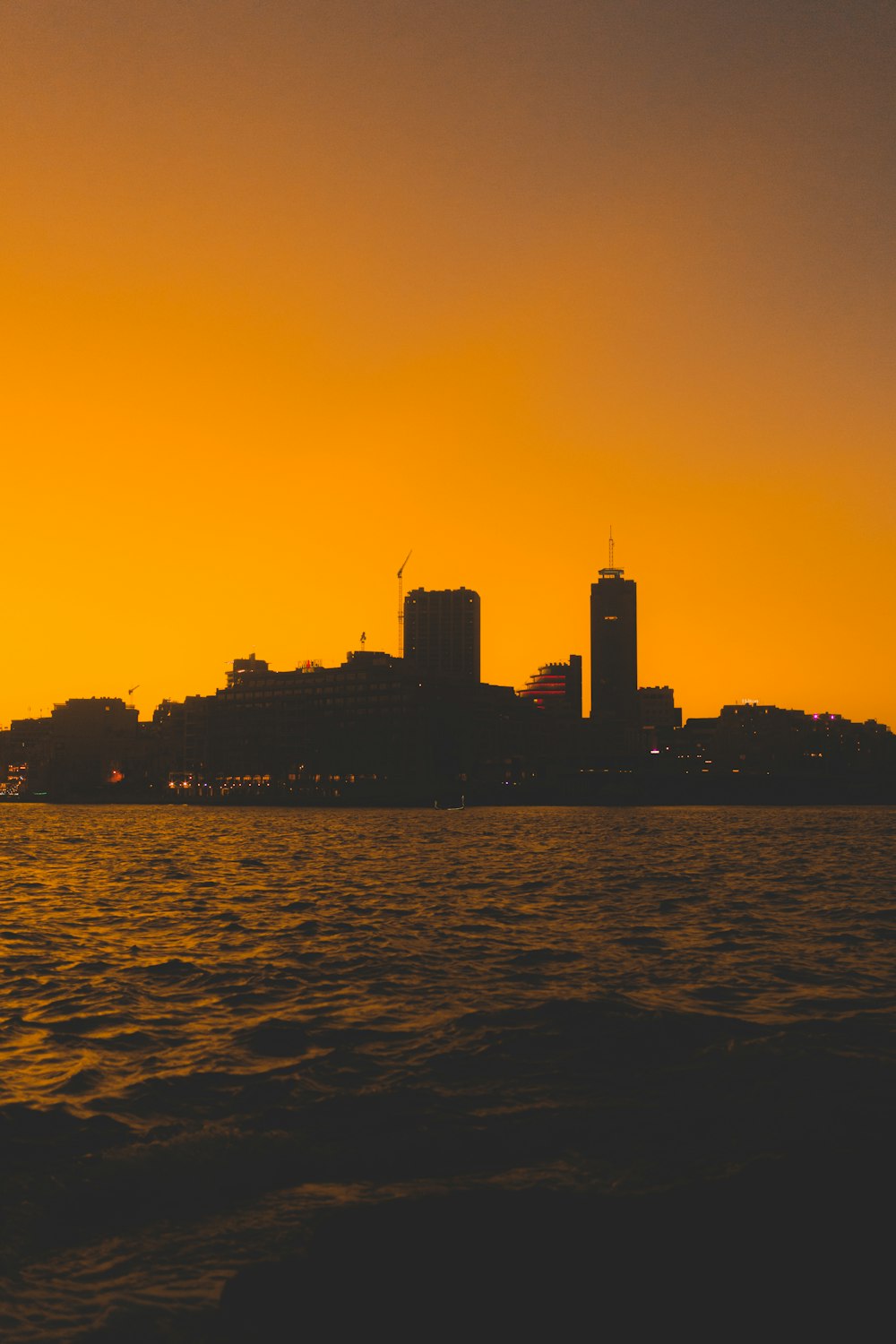 a large body of water with a city in the background