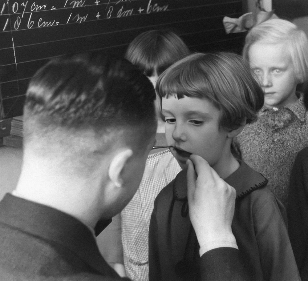 a black and white photo of a boy and a girl