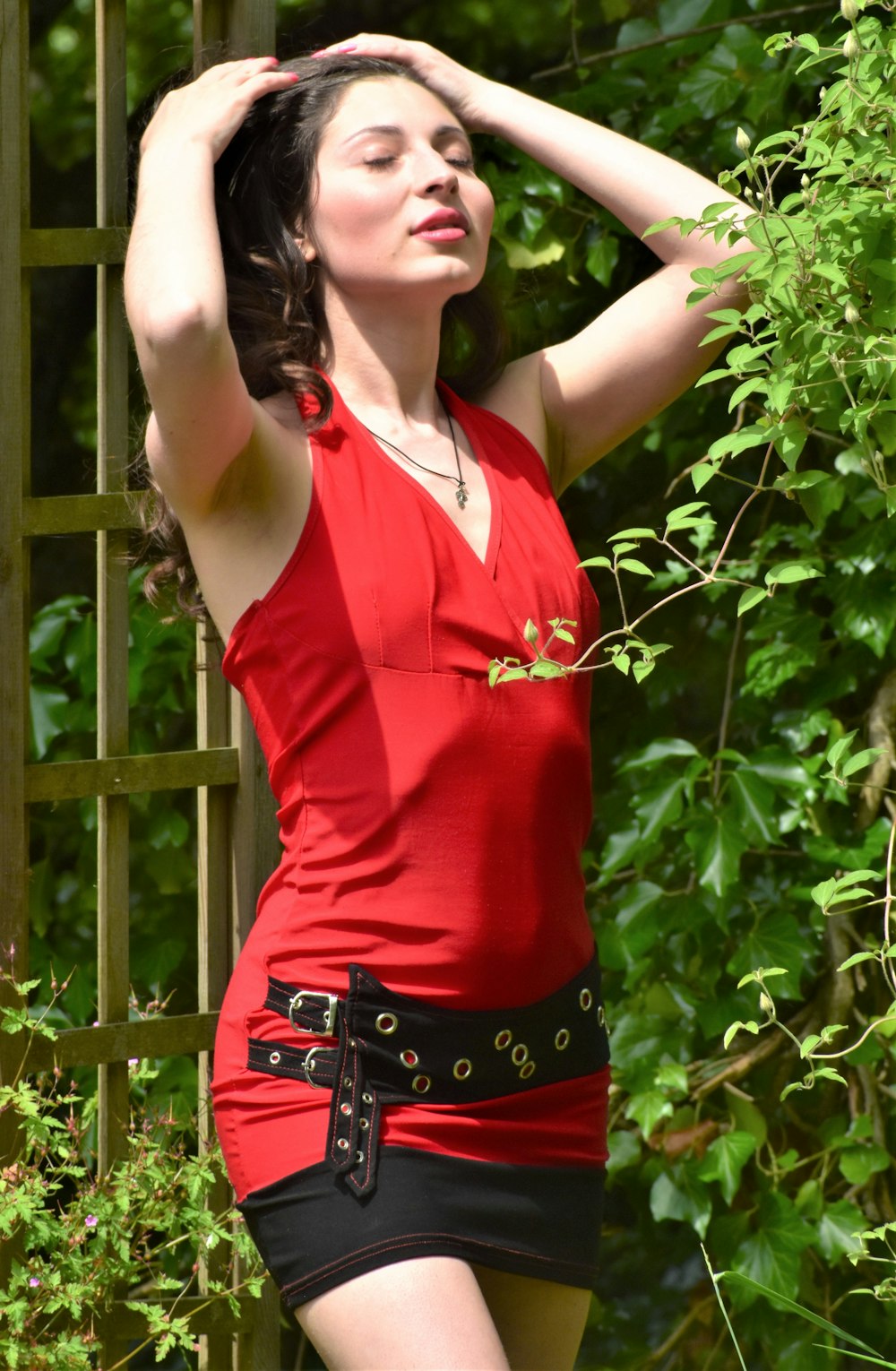 a woman in a red shirt and black skirt