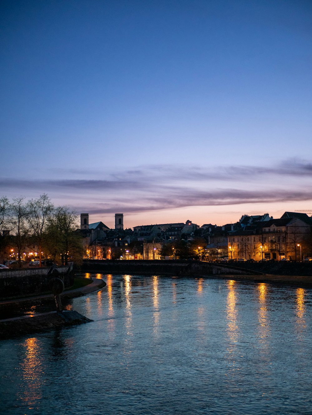 a body of water with buildings in the background