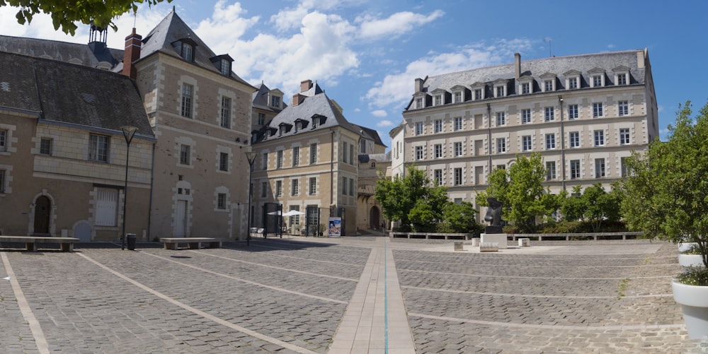 a cobblestone street with a building in the background