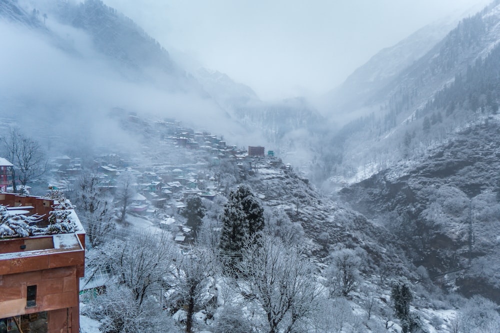 a snow covered mountain with a village in the distance