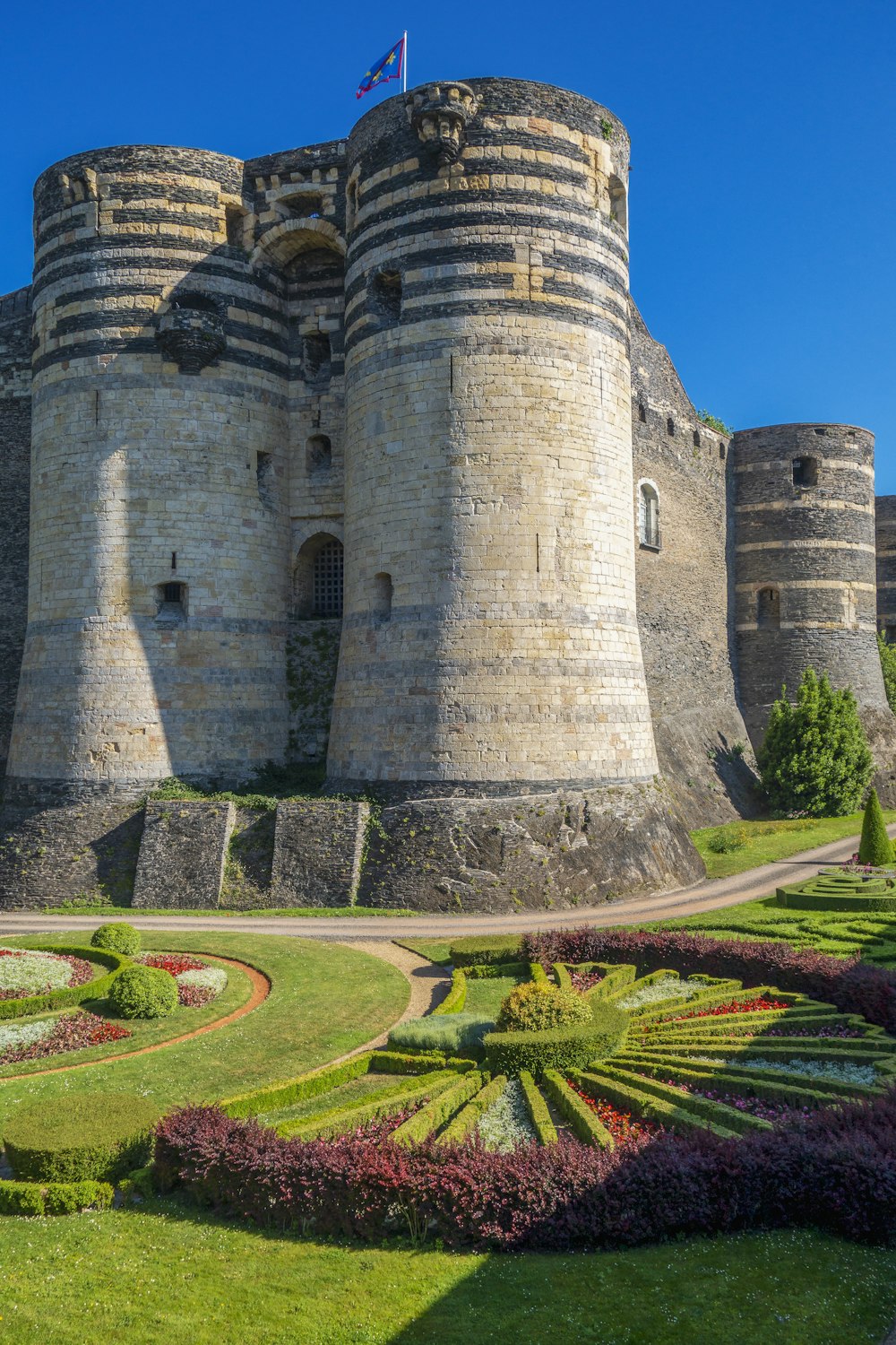 a castle with a garden in front of it