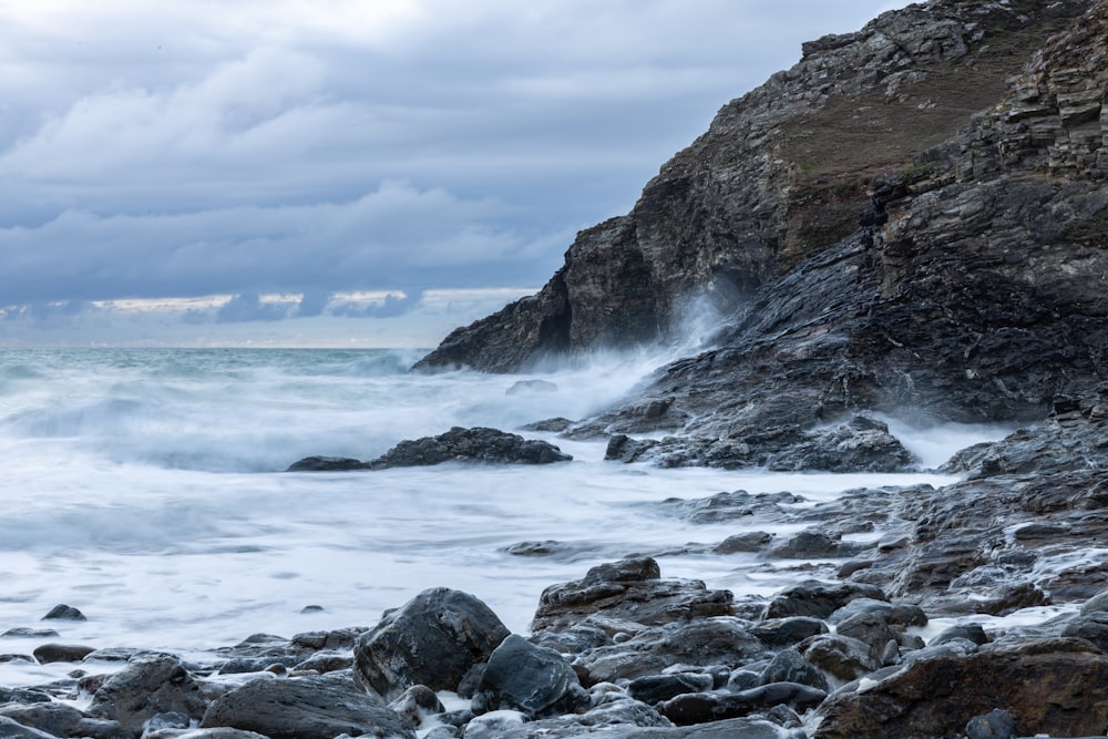 a rocky beach with waves crashing against the rocks